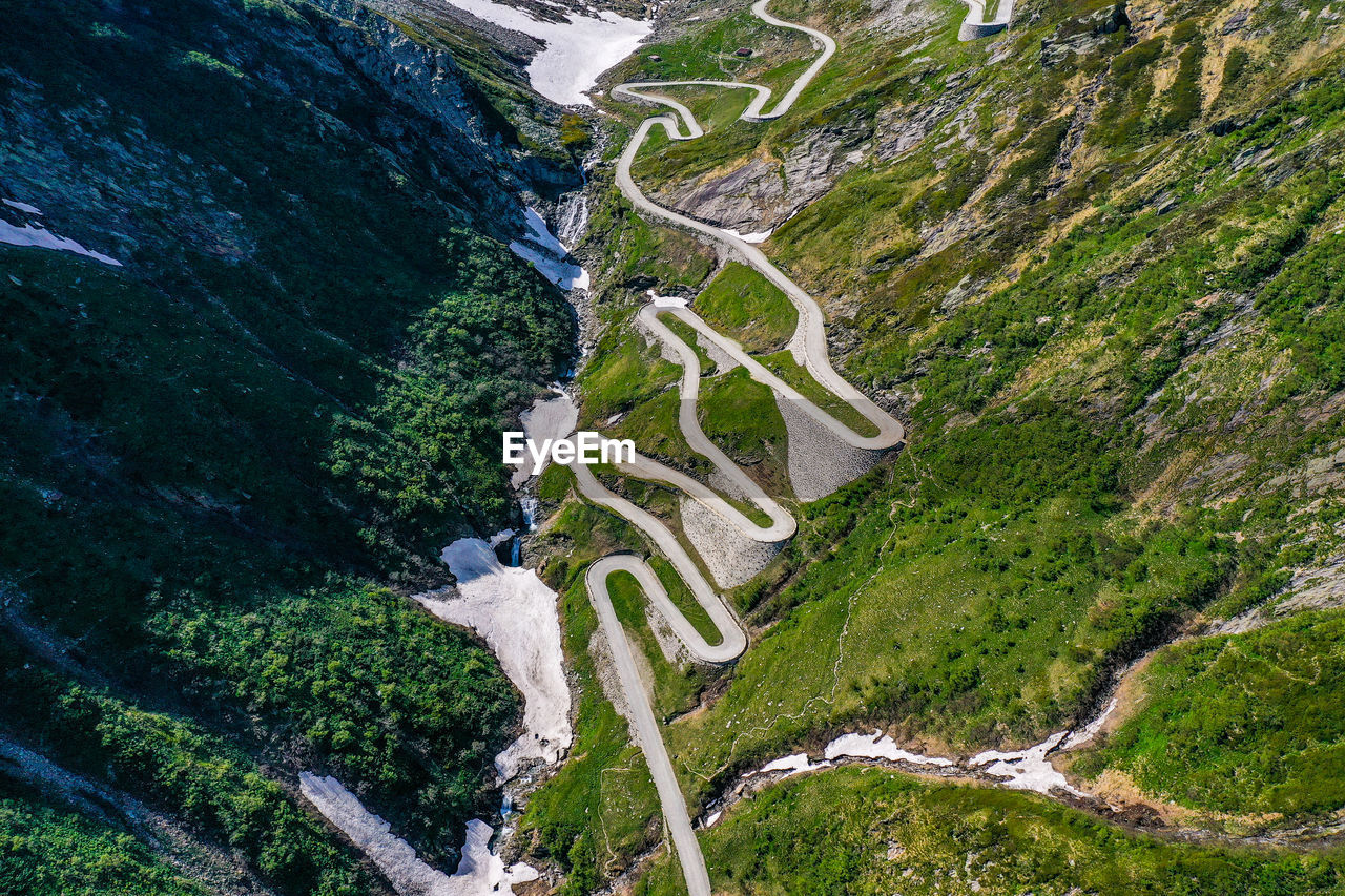 HIGH ANGLE VIEW OF ROAD AMIDST TREES ON MOUNTAIN