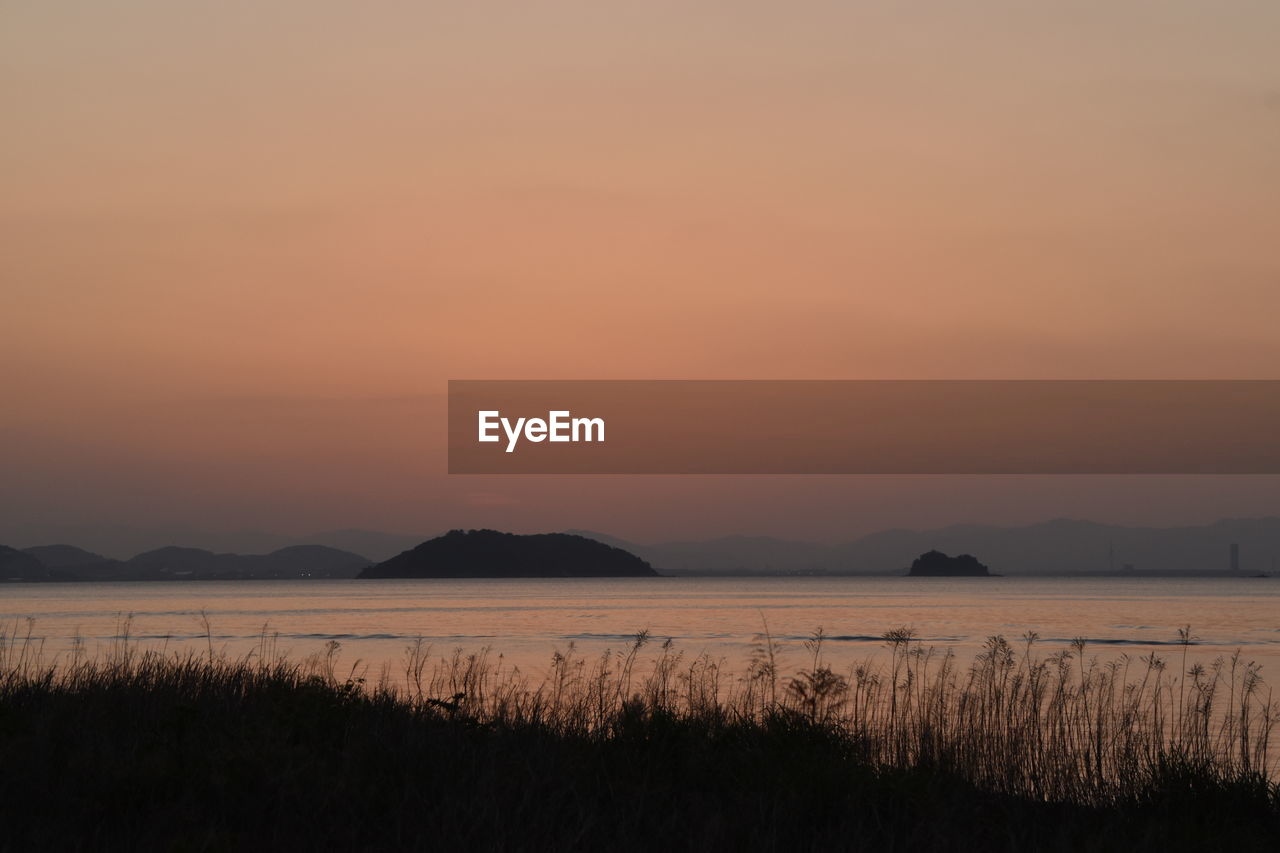 SCENIC VIEW OF LAKE DURING SUNSET