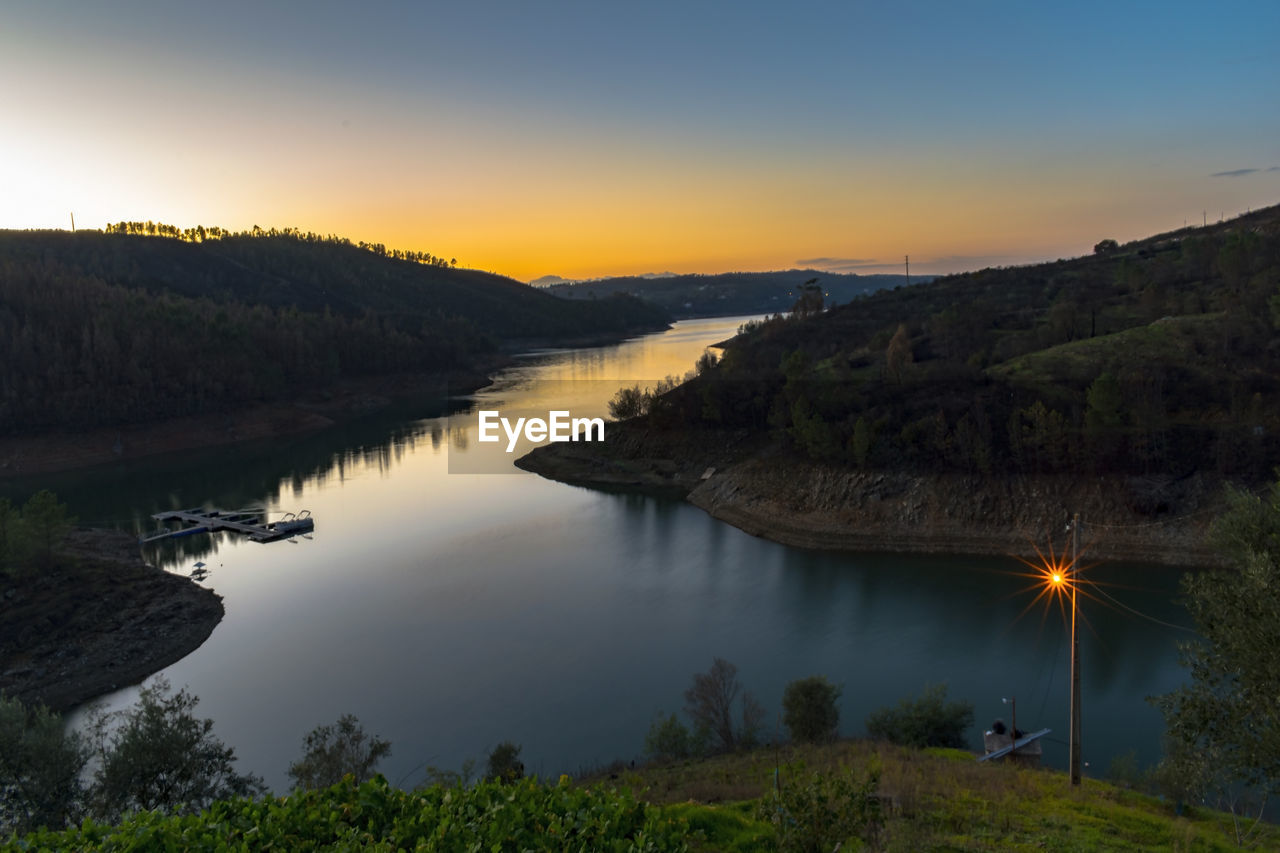 SCENIC VIEW OF RIVER AT SUNSET