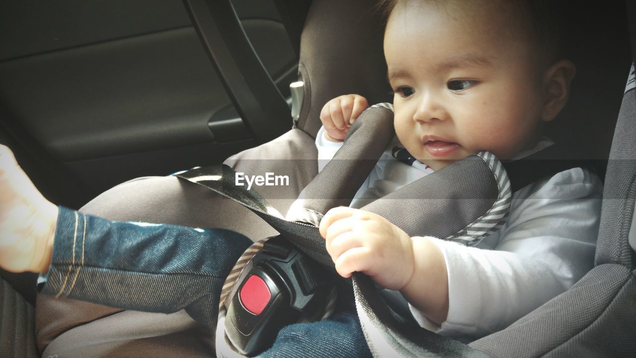 Close-up of baby sitting in car