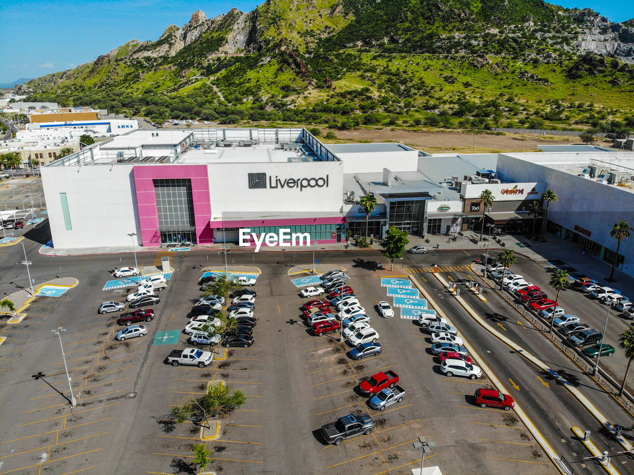 HIGH ANGLE VIEW OF PARKING LOT BY BUILDING