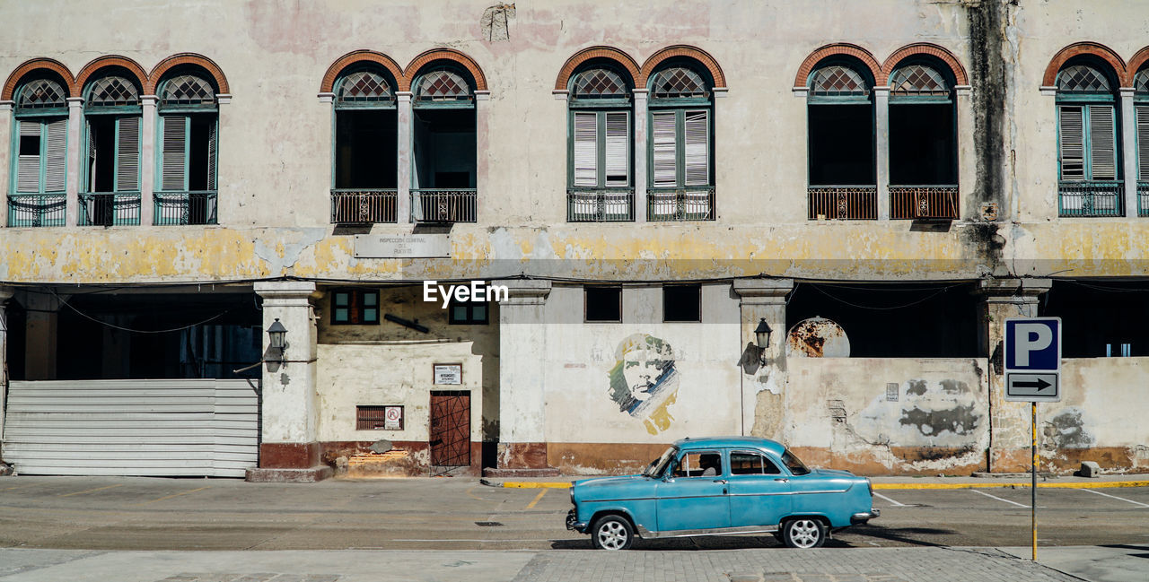 CAR ON STREET AGAINST BUILDING