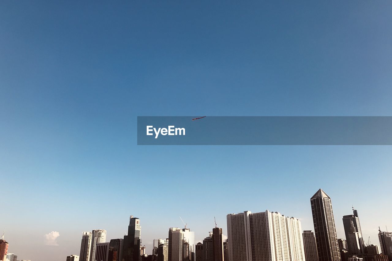 LOW ANGLE VIEW OF BUILDINGS AGAINST CLEAR SKY