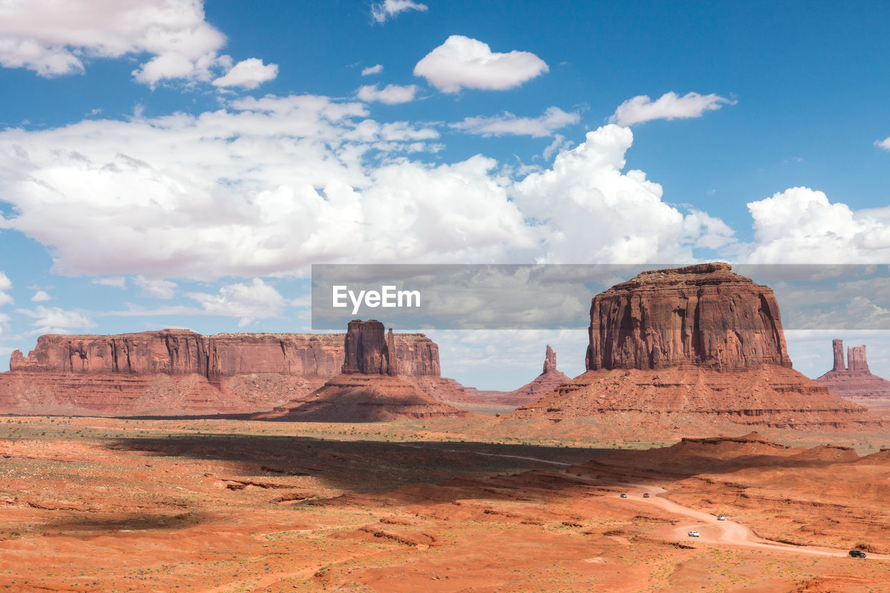 Scenic view of rock formations against cloudy sky