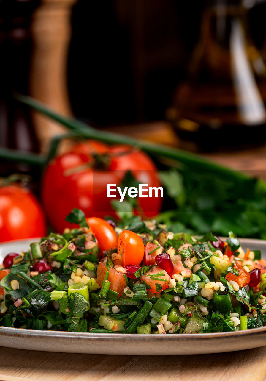 food and drink, food, vegetable, healthy eating, wellbeing, freshness, tomato, fruit, salad, dish, produce, no people, plate, meal, vegetarian food, indoors, focus on foreground, organic, lettuce, herb, close-up, red, green, cherry tomato, cuisine