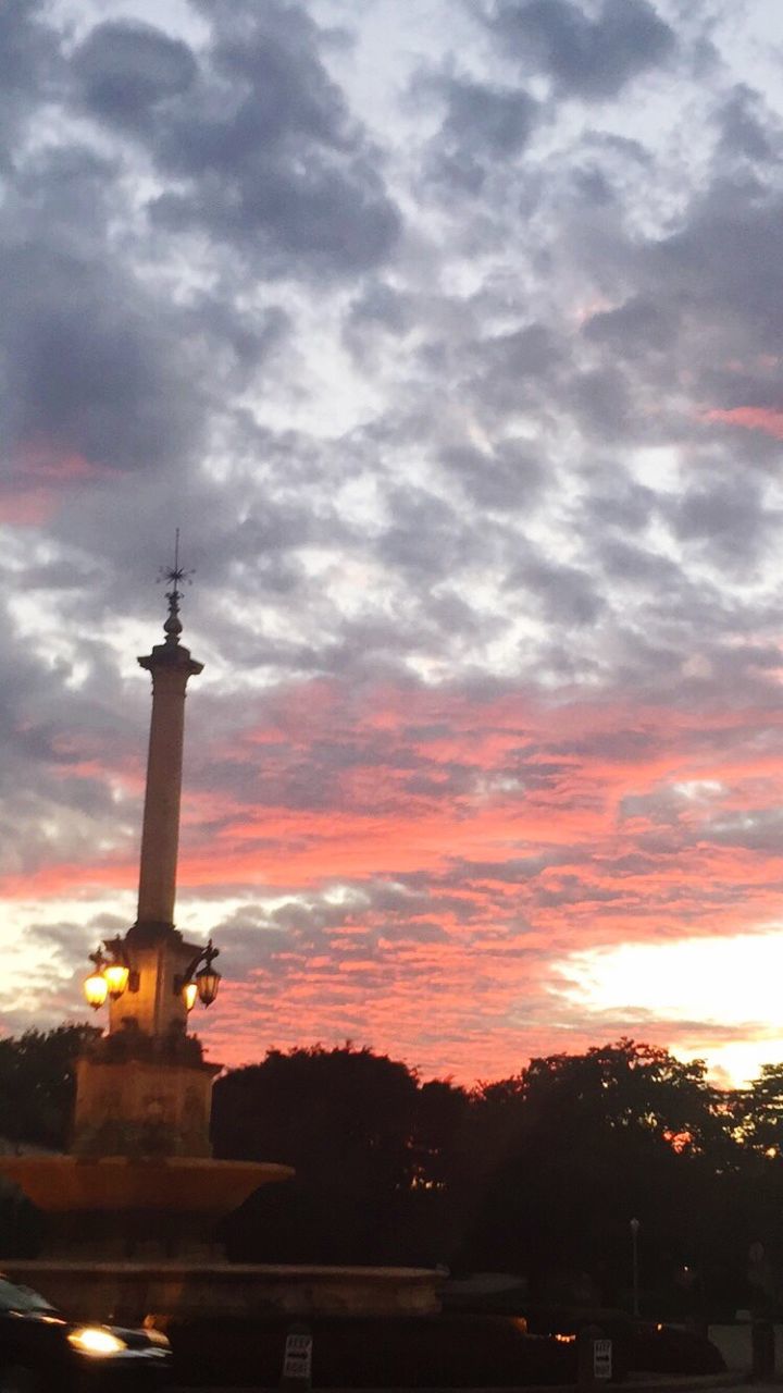 Communications tower against cloudy sky