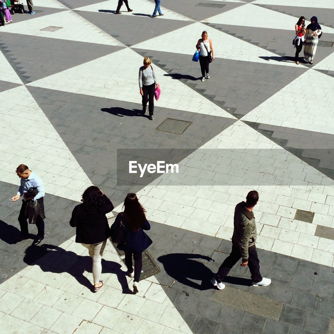 High angle view of people walking on city street