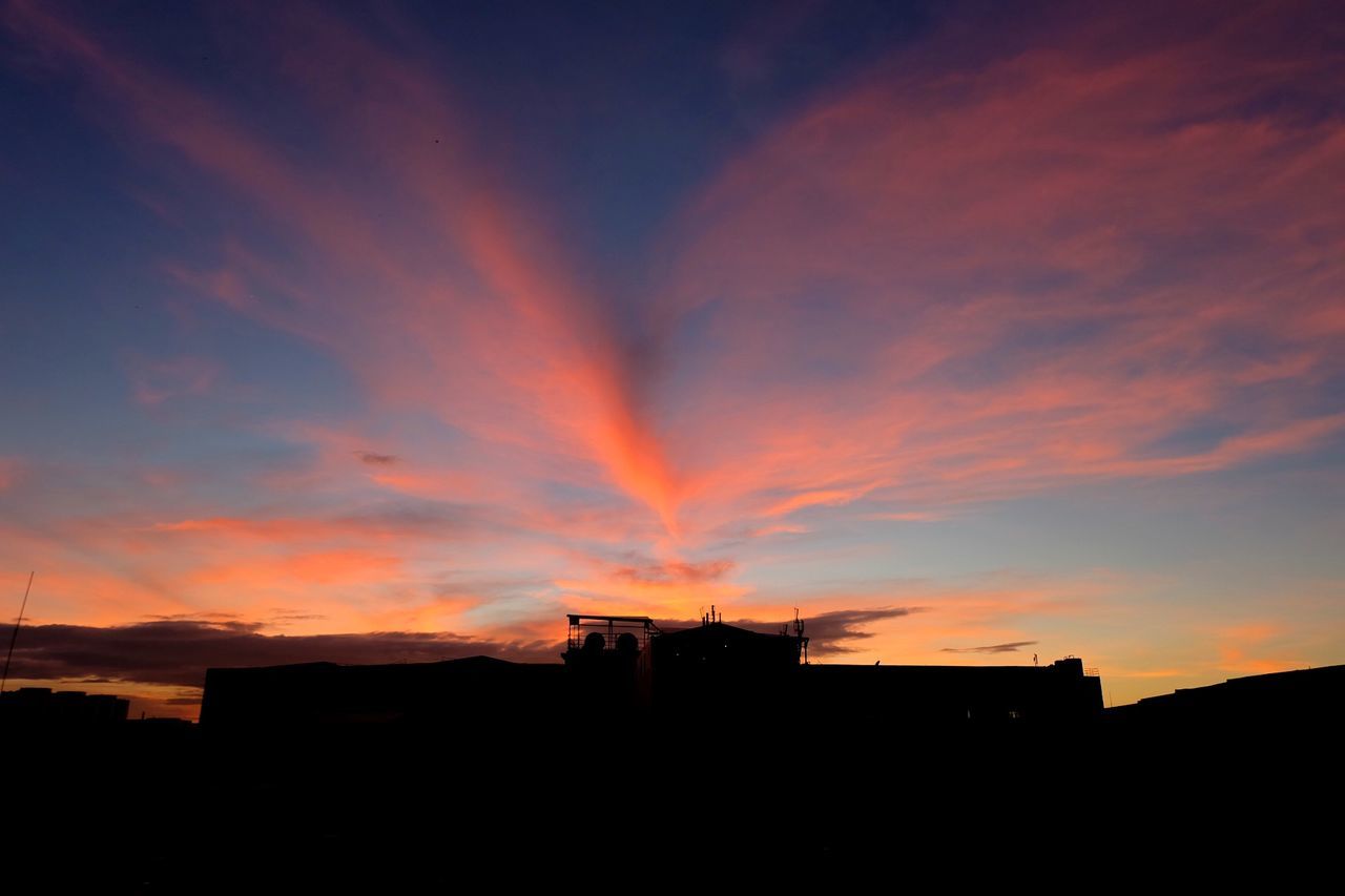 Silhouette buildings against sky during sunset