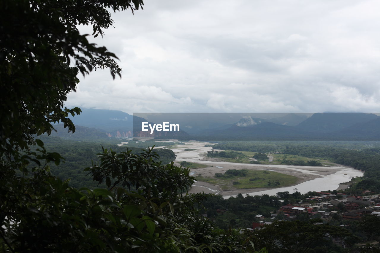 SCENIC VIEW OF MOUNTAINS AGAINST CLOUDY SKY