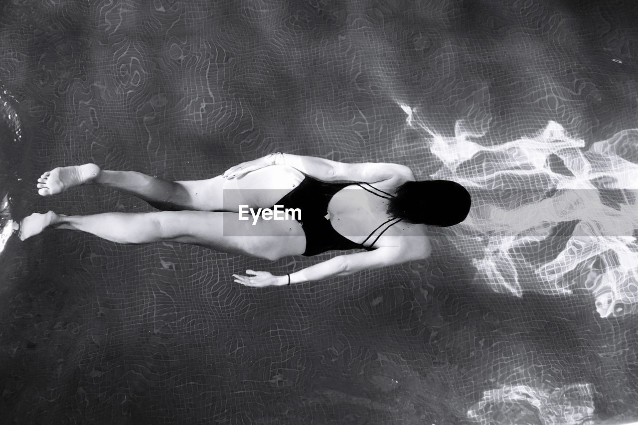 High angle view of woman swimming in pool