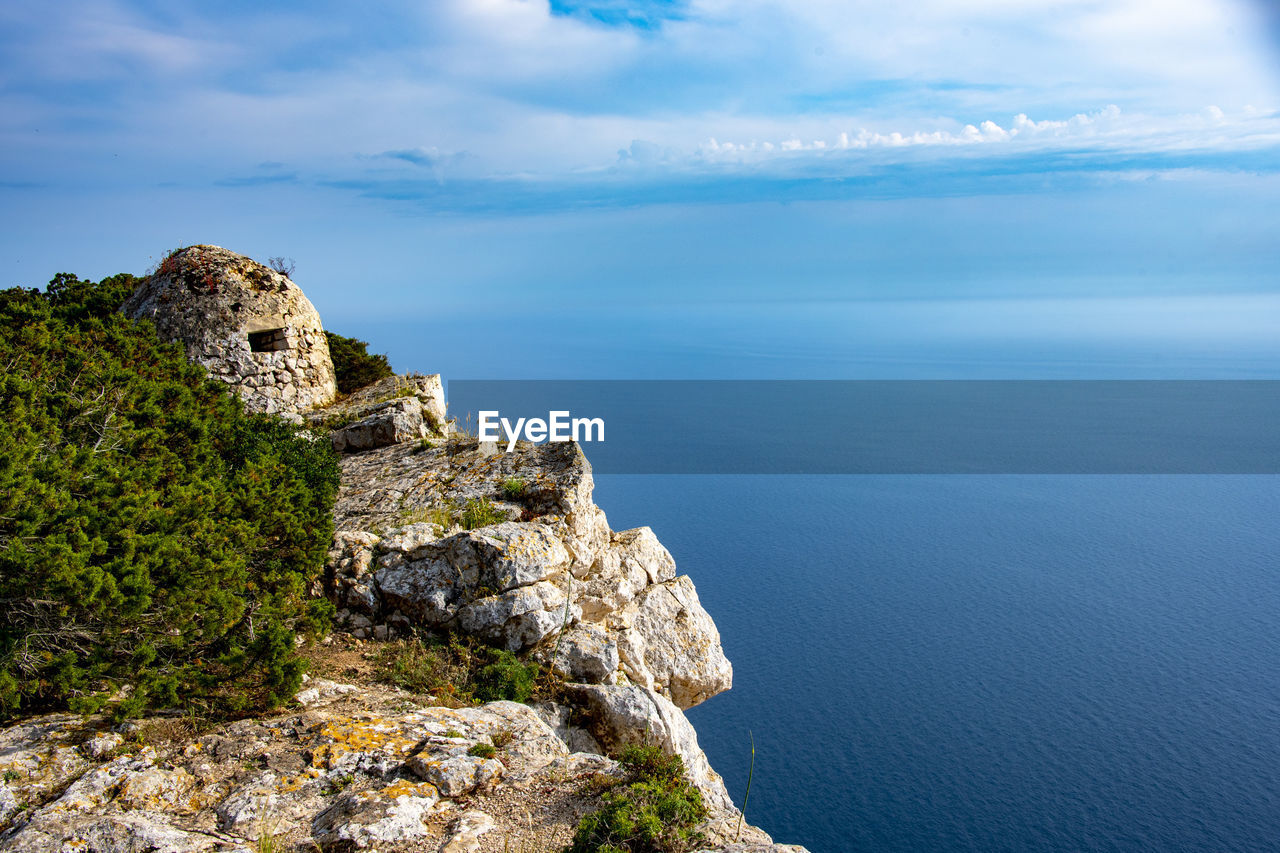 water, sea, coast, sky, scenics - nature, cliff, cloud, nature, land, beauty in nature, rock, travel destinations, environment, beach, landscape, horizon, architecture, travel, ocean, tranquility, coastline, terrain, history, tranquil scene, shore, no people, mountain, outdoors, blue, the past, tourism, built structure, horizon over water, idyllic, day, rock formation, plant, island, building, holiday, non-urban scene, building exterior, bay, trip, tree, vacation, high angle view, seascape, summer, tower, ancient