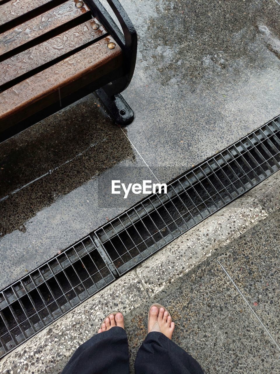 Low section of woman standing on railroad track