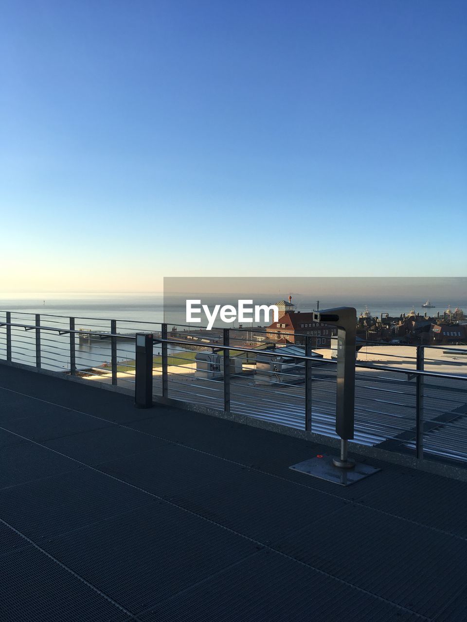 SCENIC VIEW OF SEA BY CITY AGAINST CLEAR SKY