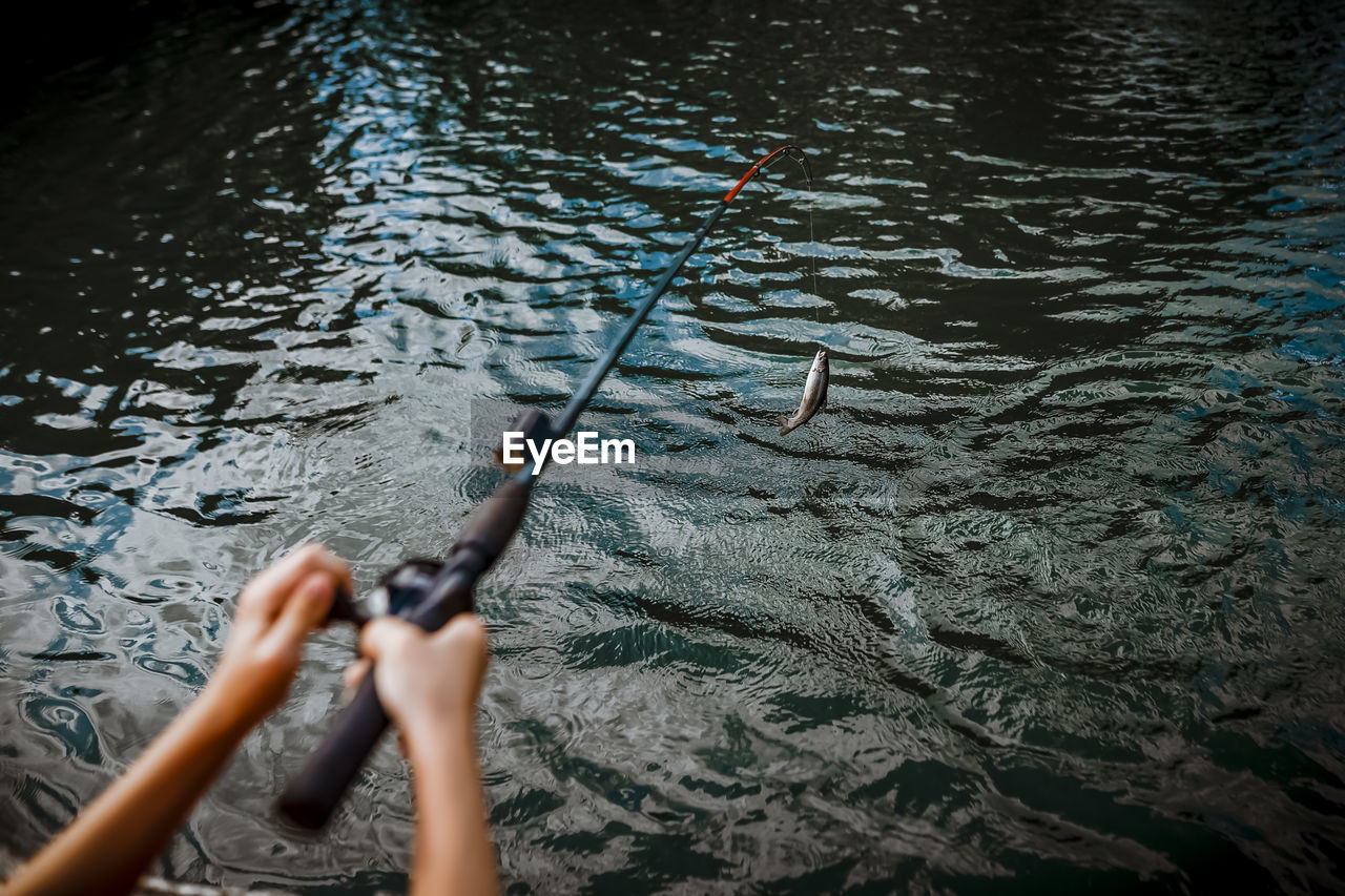 7 years old boy getting a fish on his fishing rod