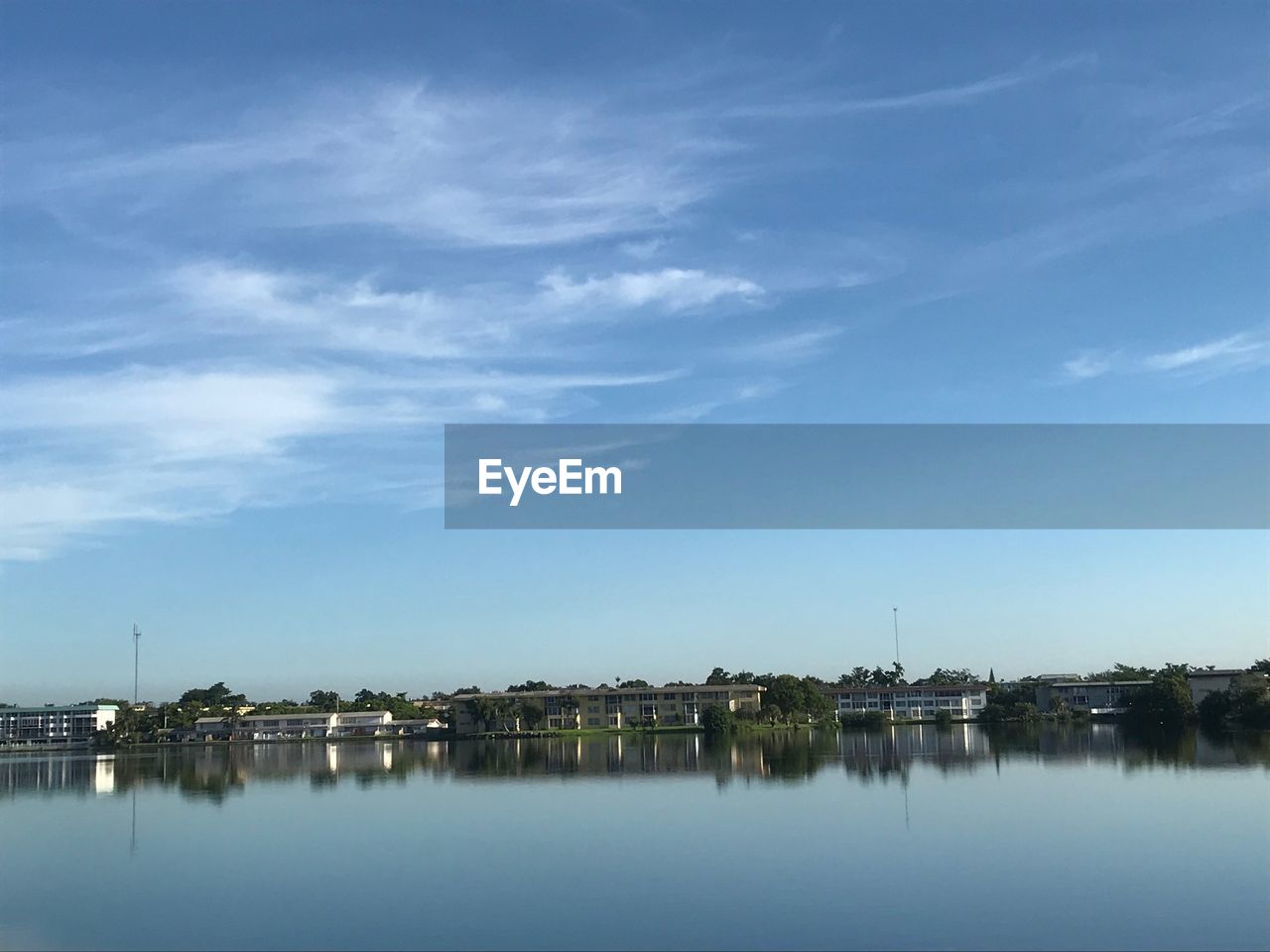 Reflection of buildings in lake against sky