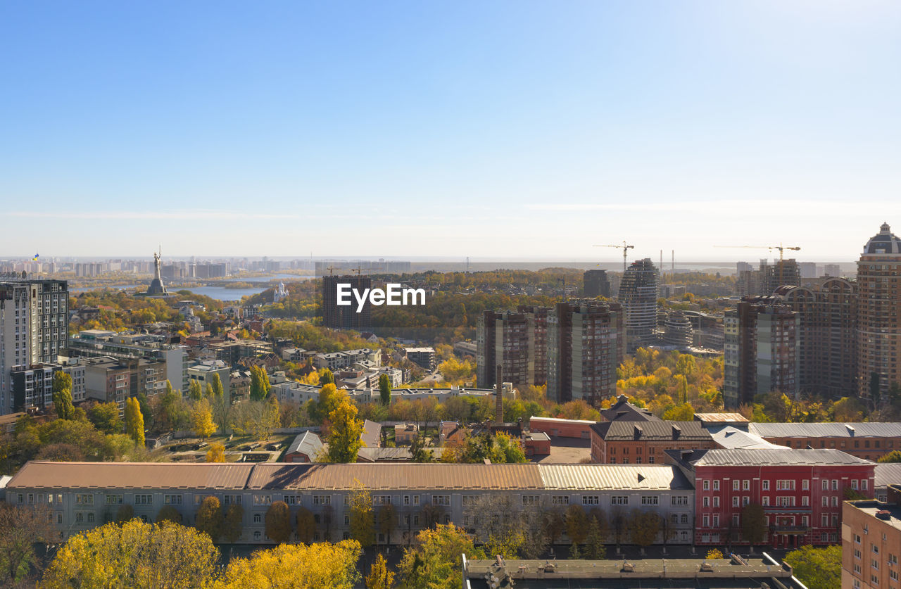 Buildings in city against clear sky