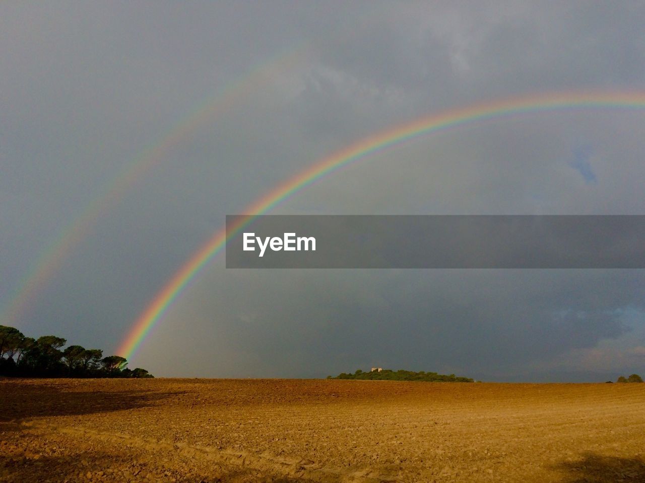 Scenic view of rainbow against cloudy sky