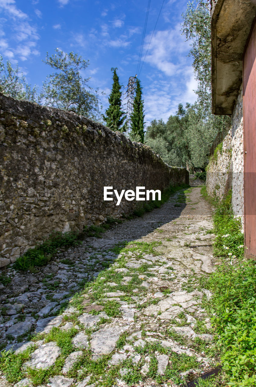 Rocky path in italy lined by a stone wall