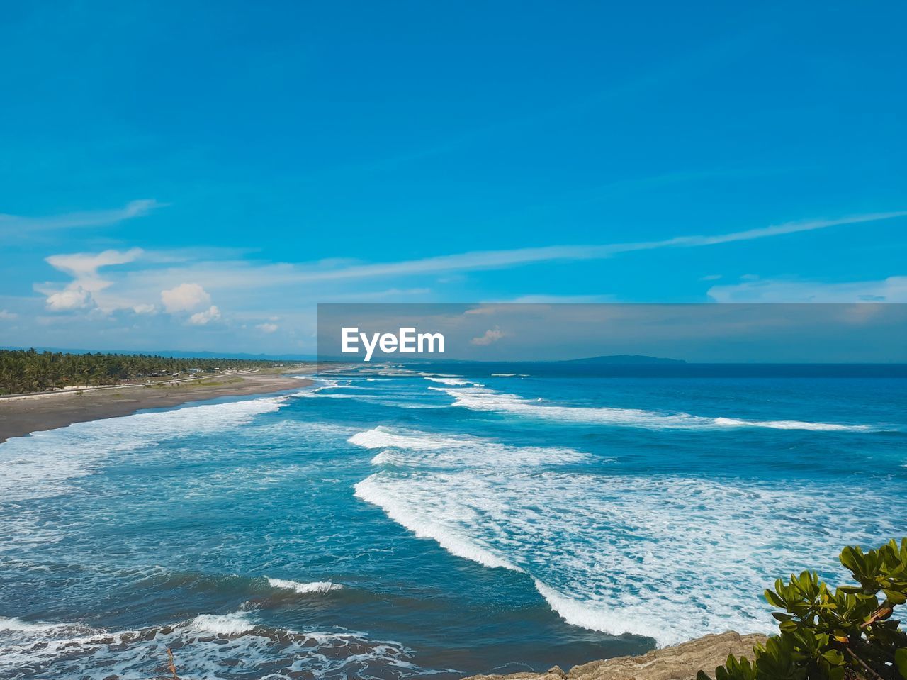 Scenic view of sea against blue sky