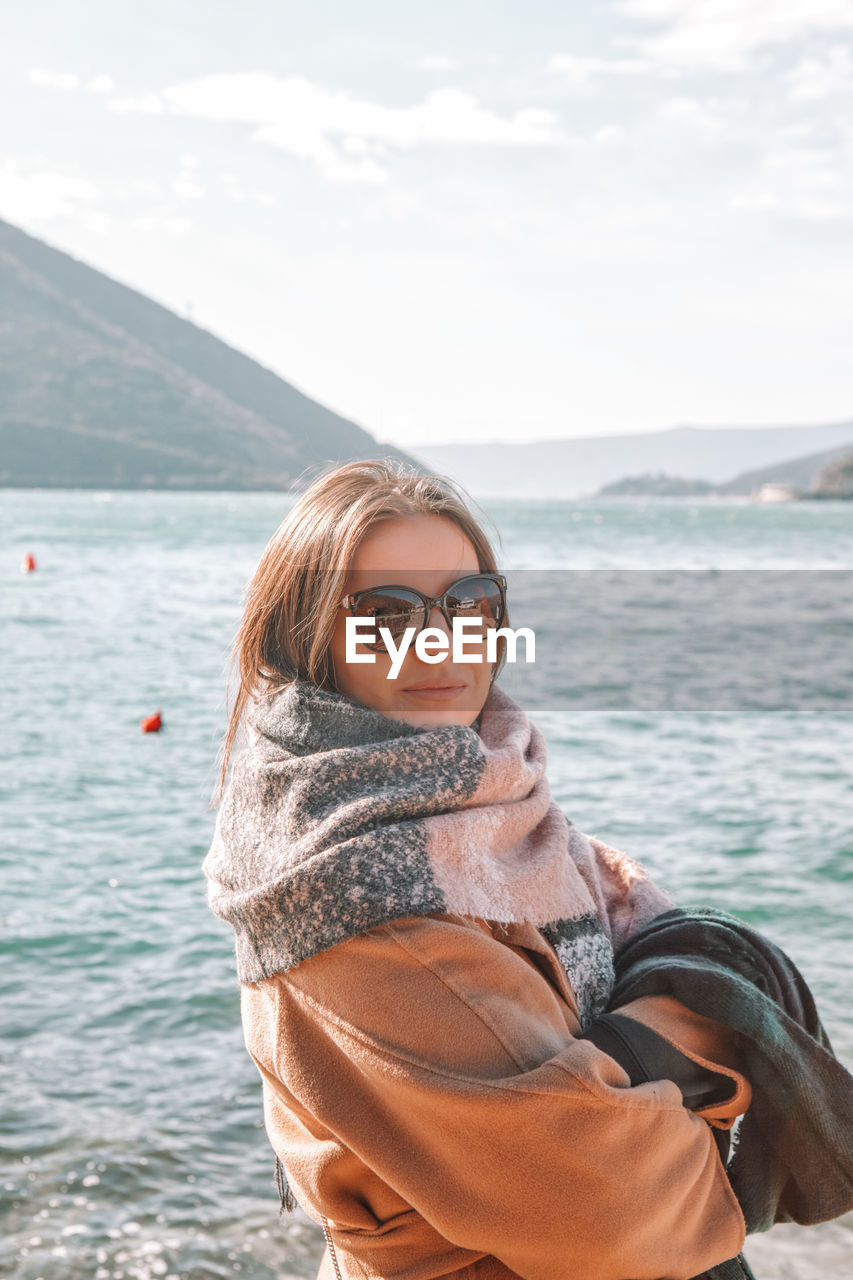 Portrait of smiling young woman in sea