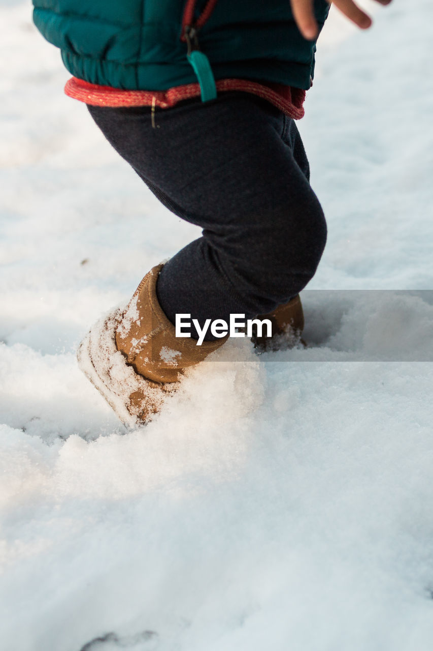 Low section of man on snow
