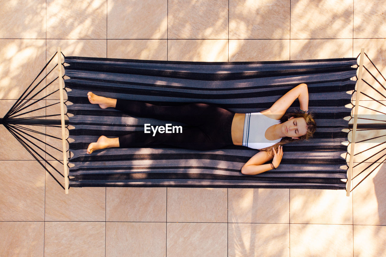Directly above shot of woman lying on hammock