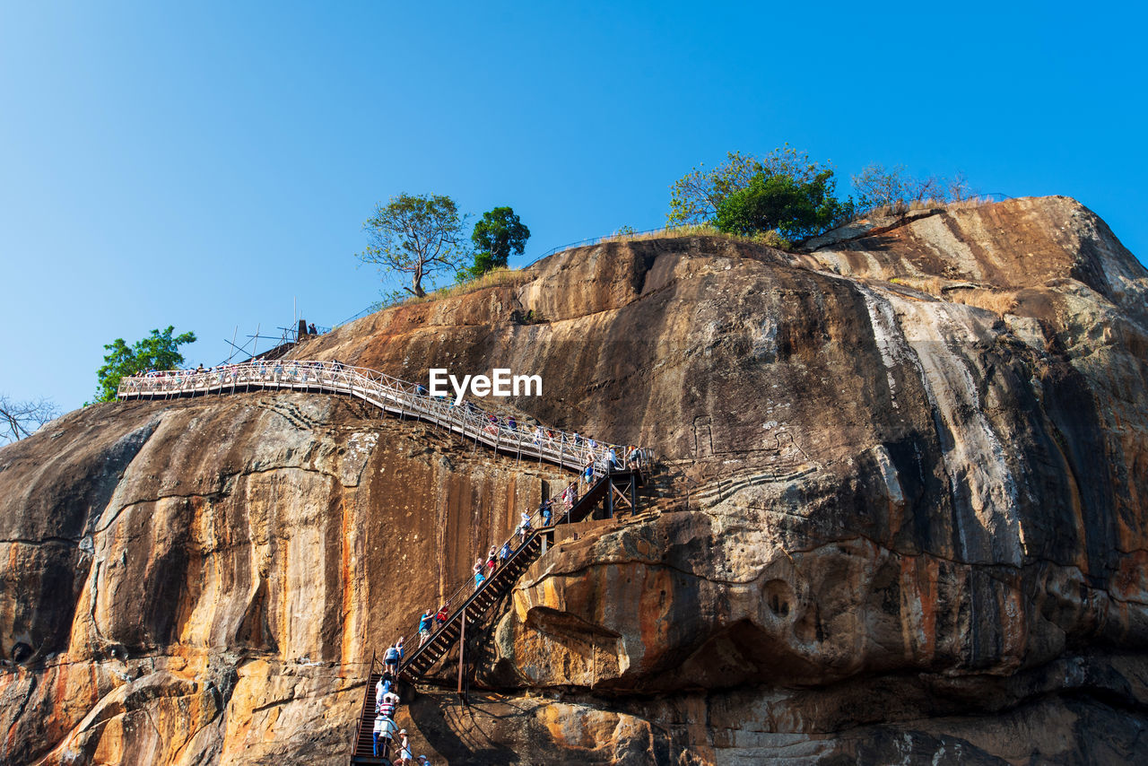 LOW ANGLE VIEW OF ROCK FORMATION AGAINST SKY