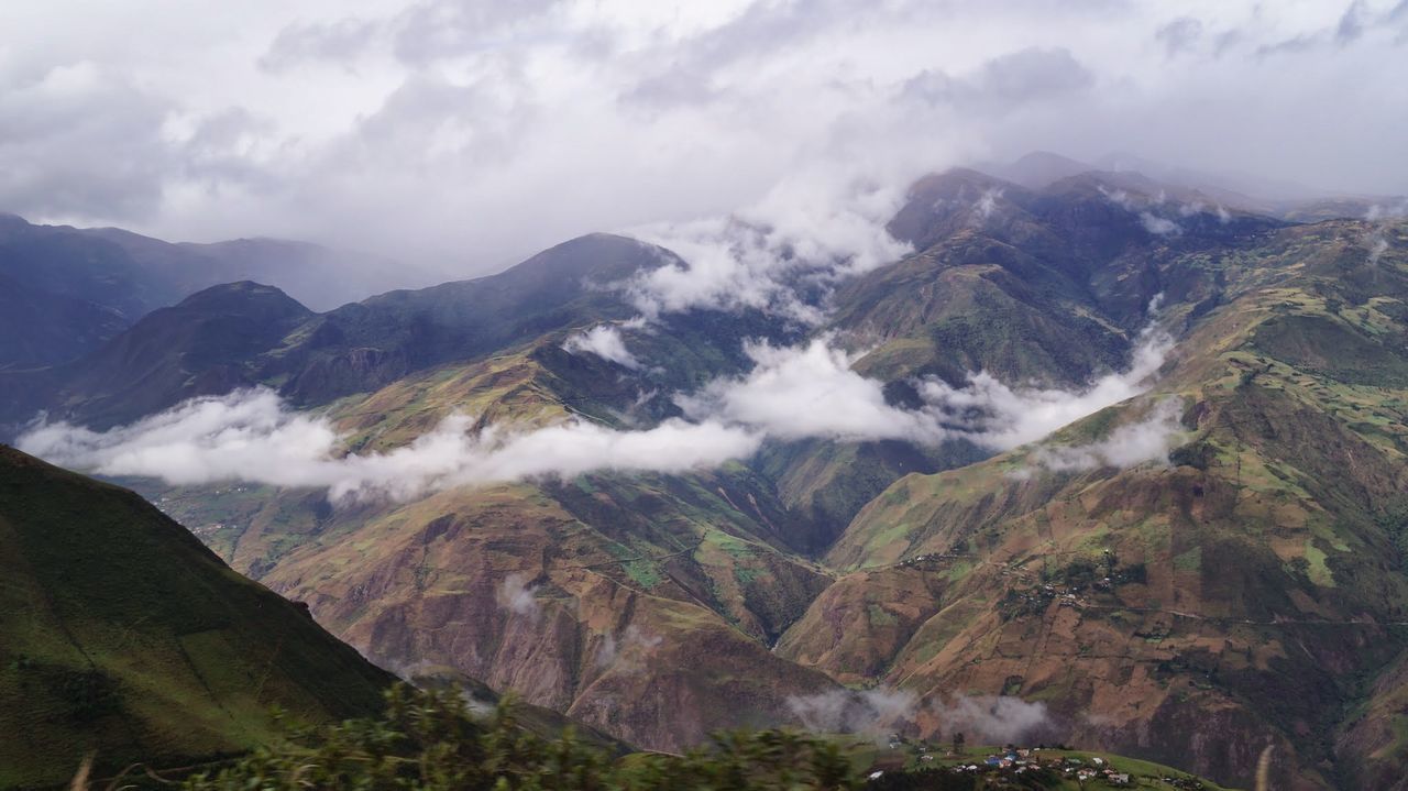 Scenic view of mountains against cloudy sky