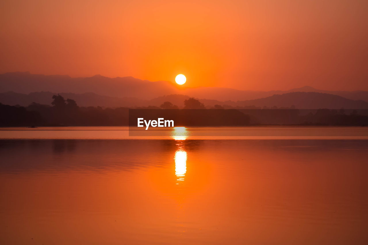 Scenic view of lake against romantic sky at sunset