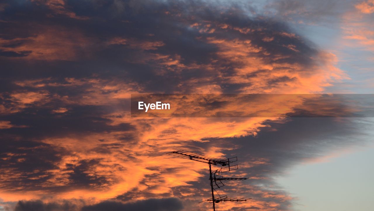 Silhouette antenna against sky during sunset