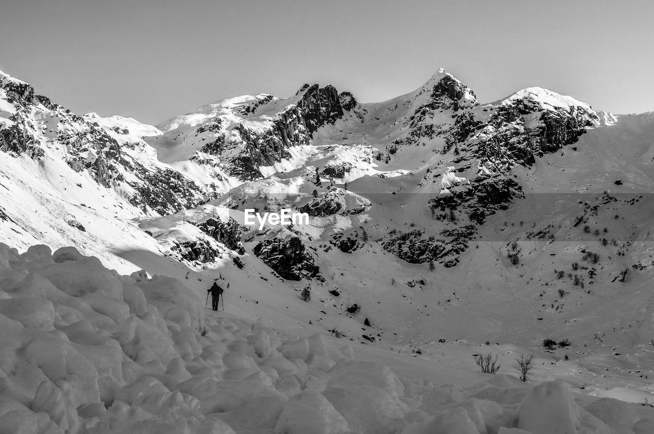 SNOW COVERED MOUNTAINS AGAINST SKY