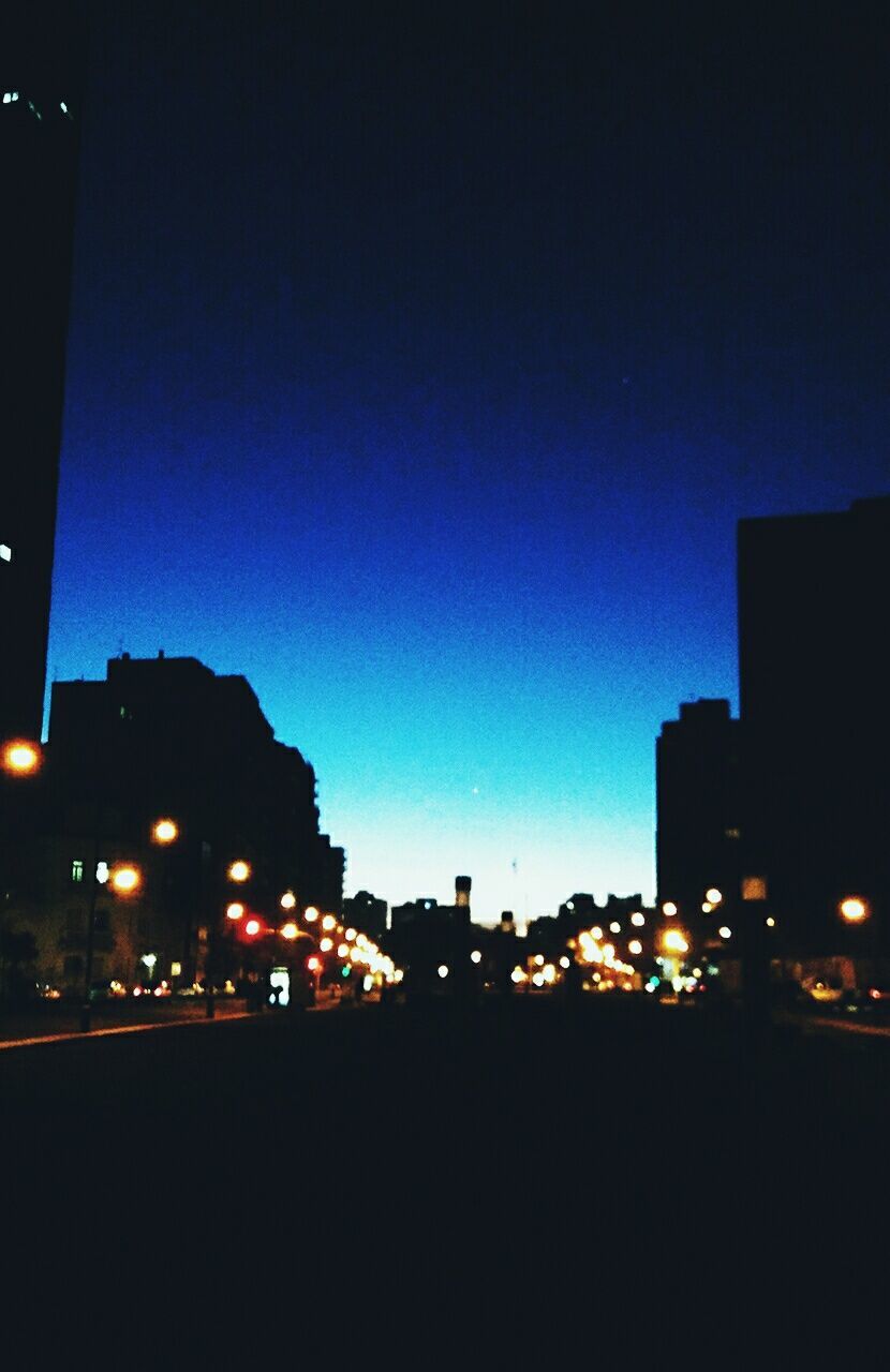 illuminated, night, architecture, building exterior, city, built structure, city life, silhouette, street light, outdoors, no people, travel destinations, clear sky, skyscraper, sky, modern, cityscape