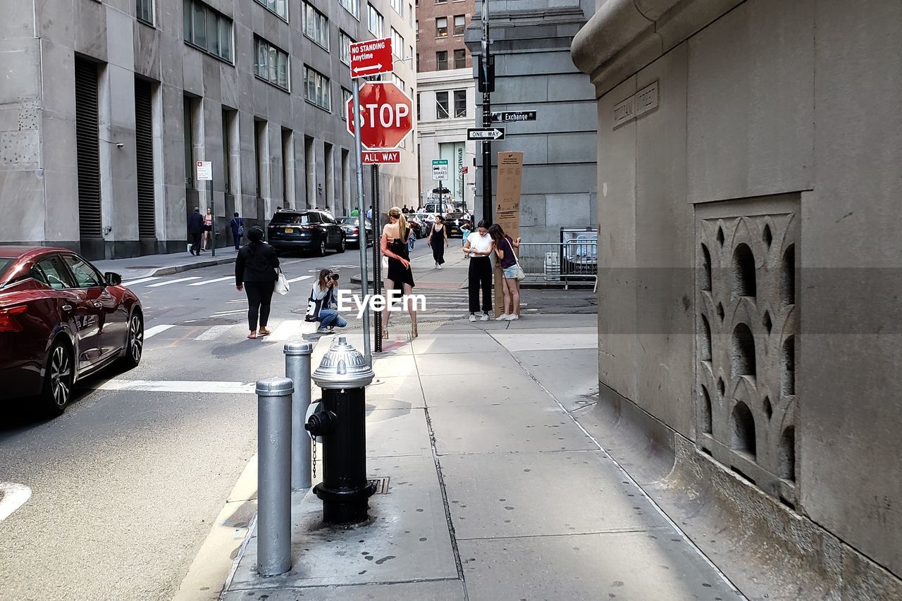 PEOPLE WALKING ON STREET IN CITY