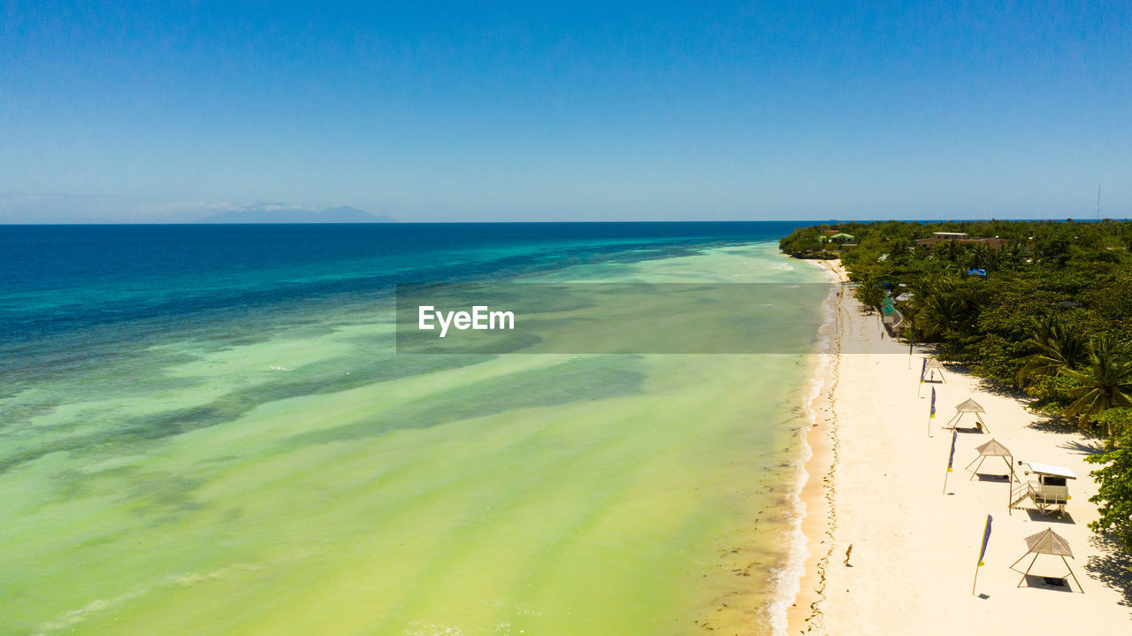 SCENIC VIEW OF BEACH AGAINST CLEAR SKY