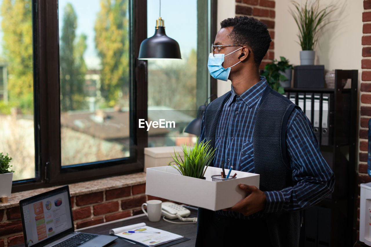 Businessman holding box in office