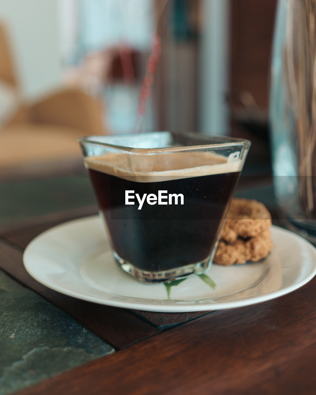 Close-up of coffee and cookies served on table