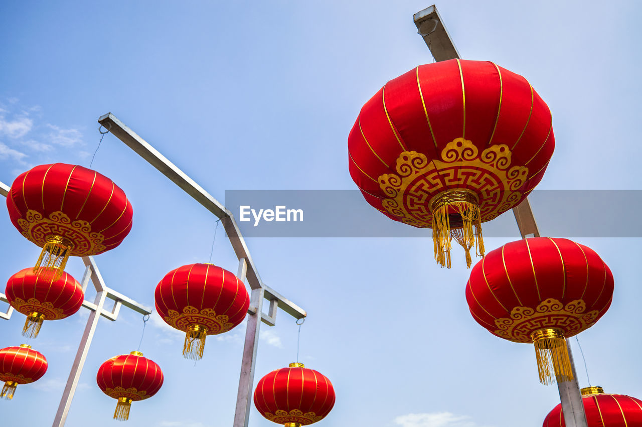 LOW ANGLE VIEW OF LANTERNS HANGING IN SKY