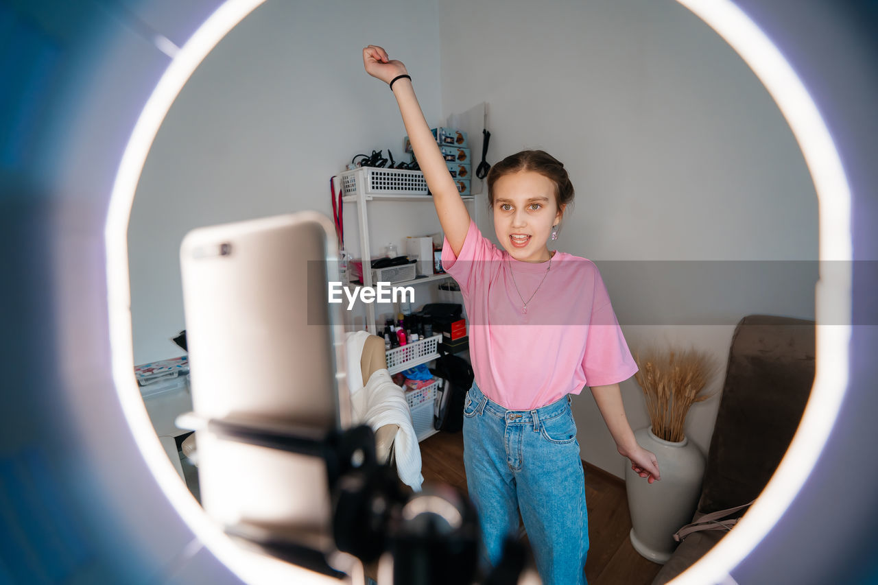 Girl teenager records video uses smartphone