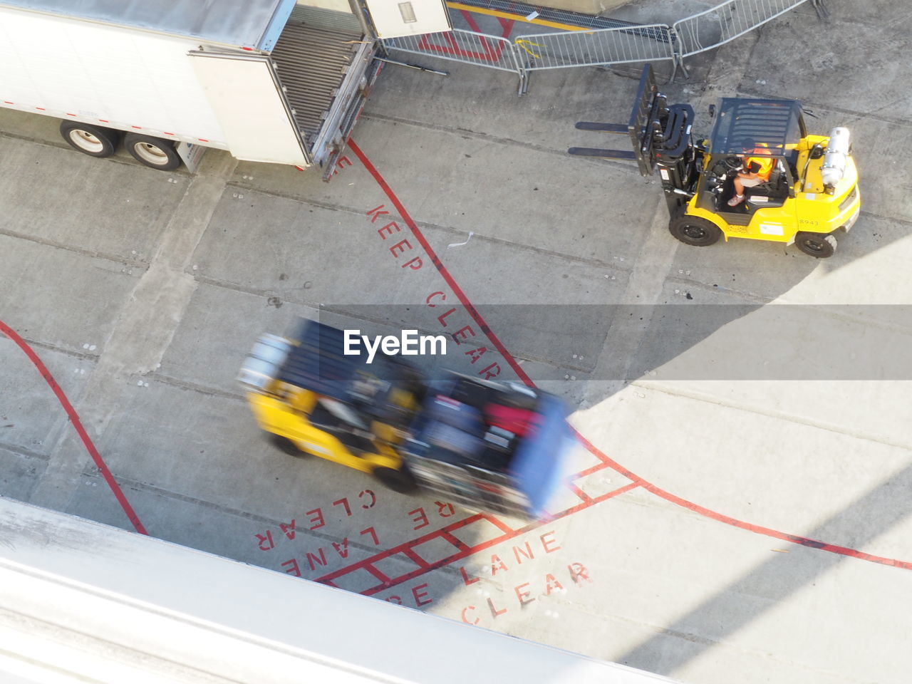 Blurred motion of forklifts in dock