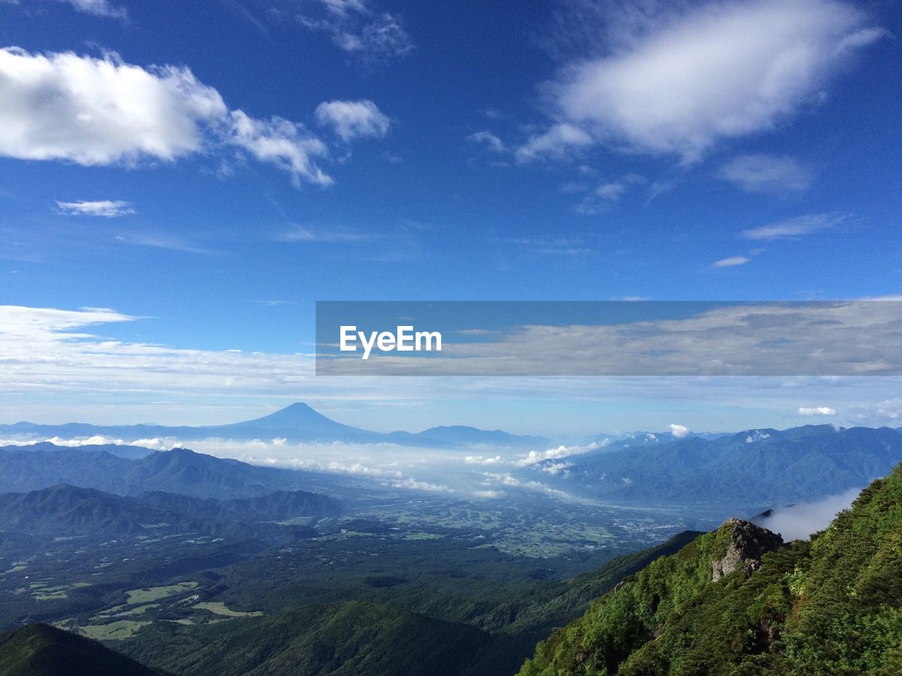 High angle view of mountains against blue sky