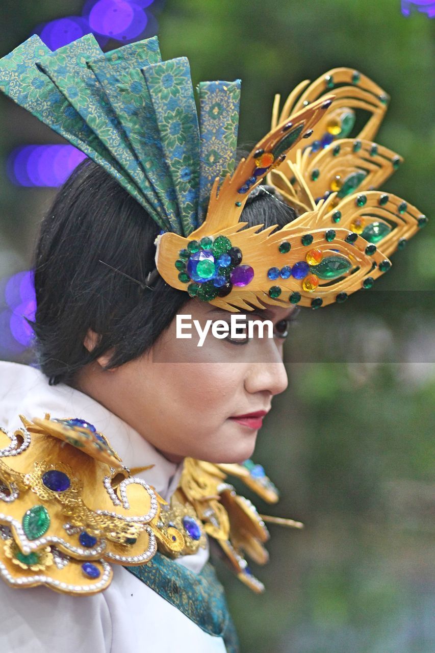 Side view of thoughtful woman in traditional clothing during festival