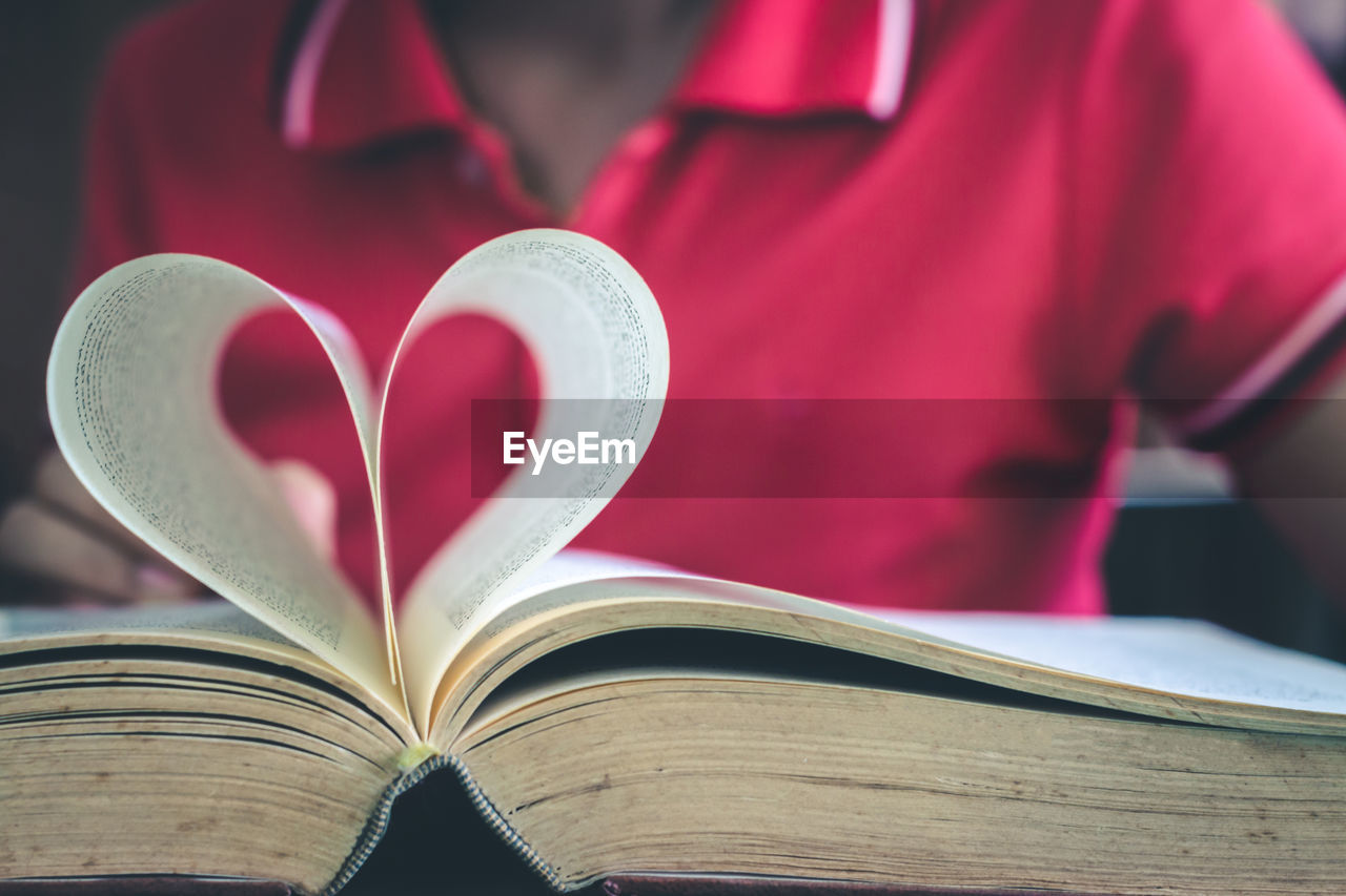 Close-up of heart shape on book