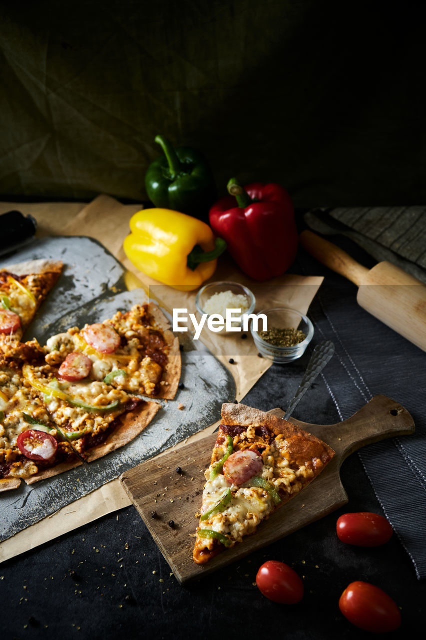 HIGH ANGLE VIEW OF PIZZA AND FRUITS ON TABLE