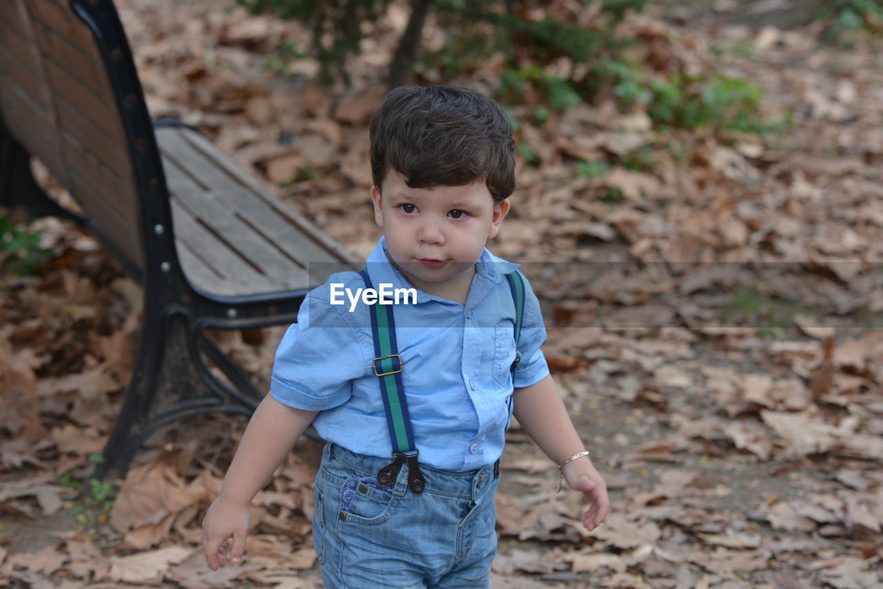 Cute boy playing at public park during autumn