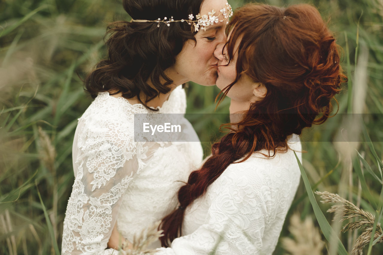 Brides kissing