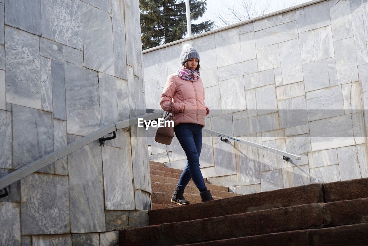 Low angle view of woman moving down on steps