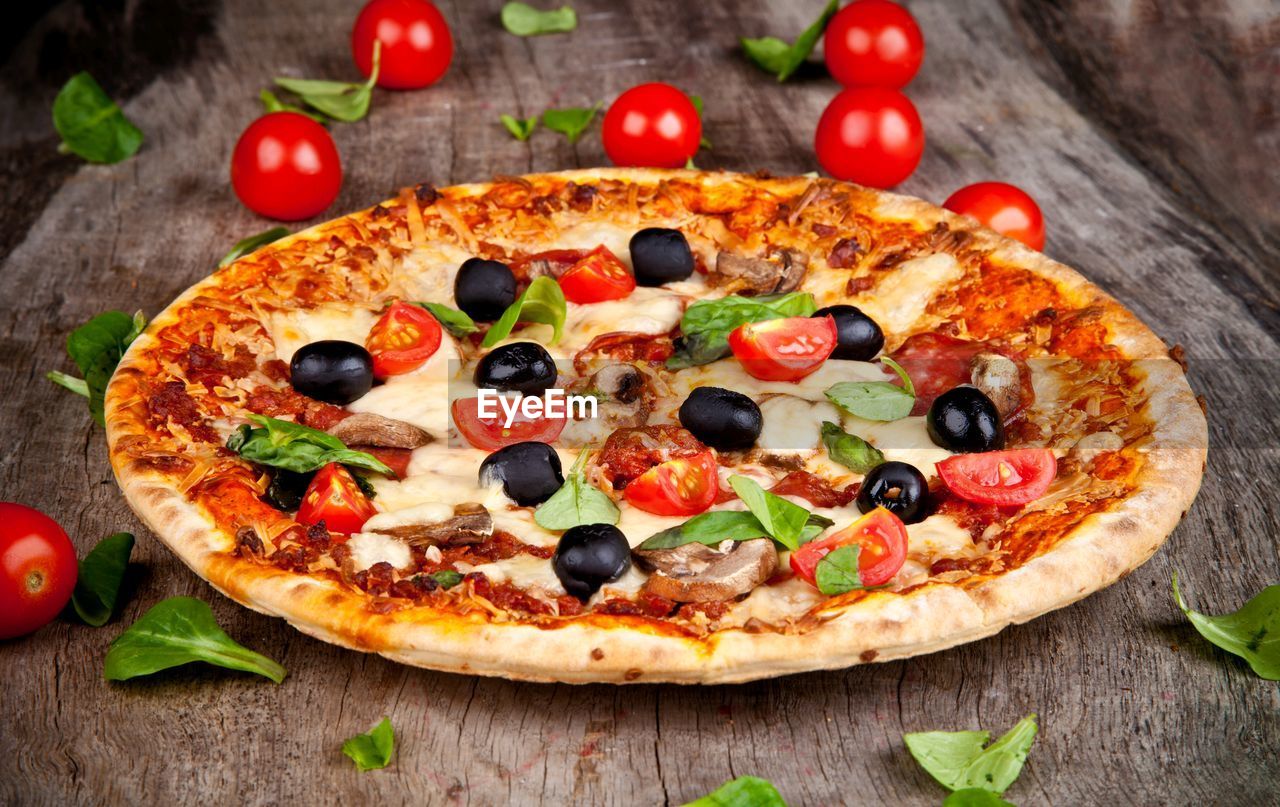 High angle view of pizza on wooden table