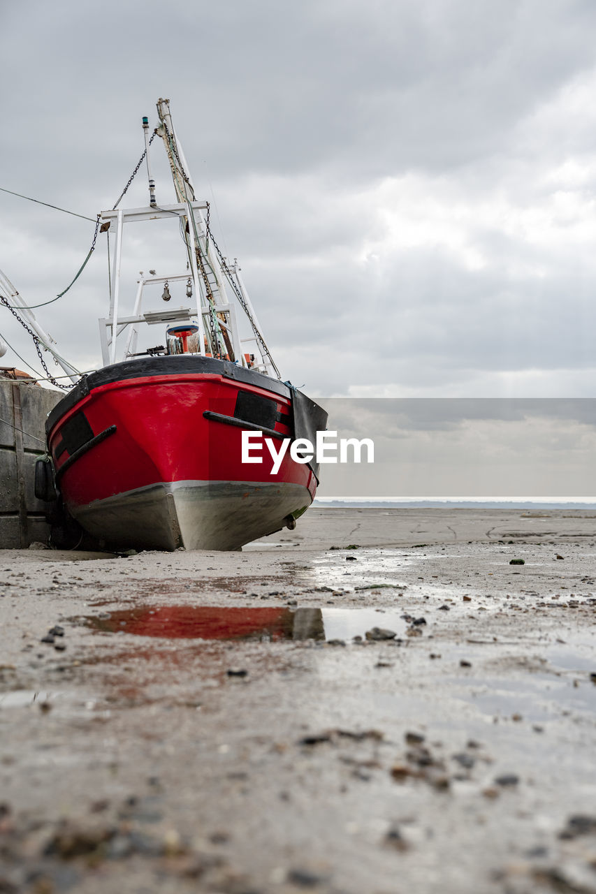 Fisherman boats stuck on the beach in low tide period in leigh-on-sea, uk.