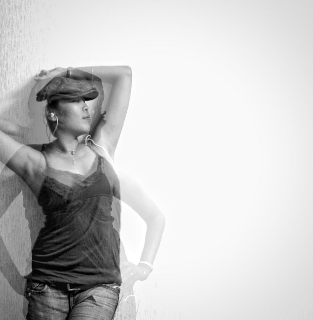 Double exposure image of woman posing by white wall
