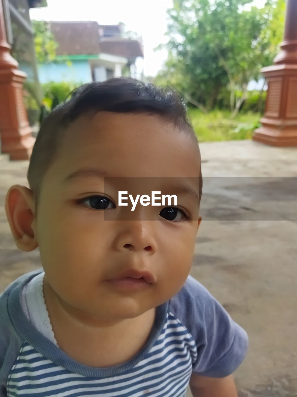 child, childhood, portrait, one person, innocence, person, looking at camera, baby, front view, cute, headshot, day, toddler, skin, human face, casual clothing, emotion, focus on foreground, smiling, looking, close-up, outdoors, lifestyles, babyhood, human eye, striped, men, nature, nose, standing